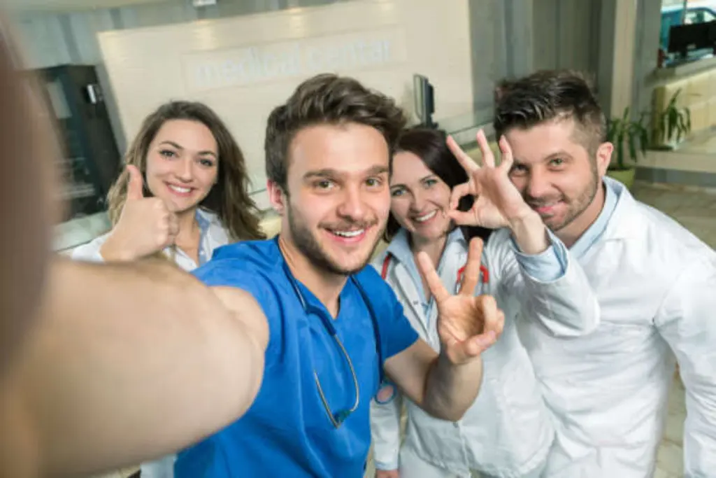 Group of physios waving at the camera