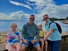 Family with two dads on holiday. Kids under the age of 12 Summer holiday vibes. Gay friendly